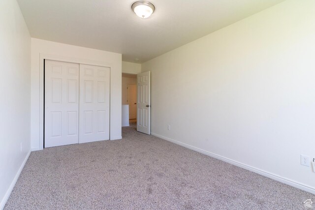 886 Cambridge Dr, North Salt Lake, UT 84054 - unfurnished bedroom featuring carpet flooring, baseboards, and a closet