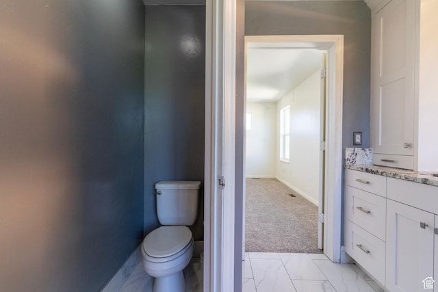 886 Cambridge Dr, North Salt Lake, UT 84054 - bathroom featuring baseboards, toilet, marble finish floors, and vanity