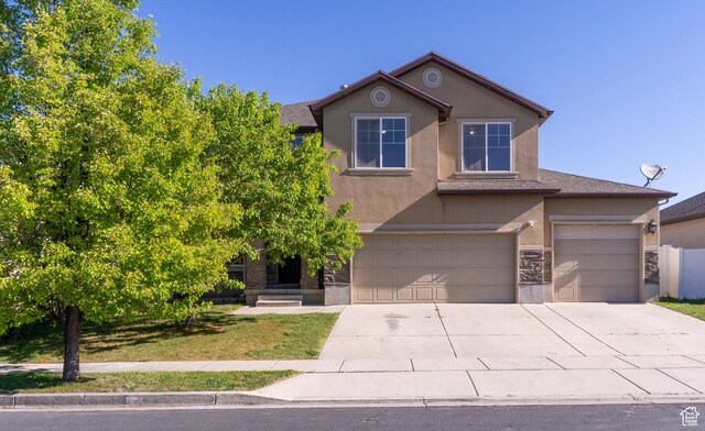 886 Cambridge Dr, North Salt Lake, UT 84054 - traditional home featuring stucco siding, concrete driveway, a garage, and stone siding