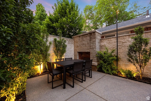 54 N B St, Salt Lake City, UT 84103 - patio terrace at dusk with outdoor dining area and an outdoor stone fireplace
