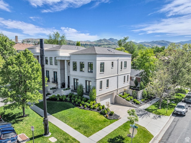 54 N B St, Salt Lake City, UT 84103 - view of front of home with a garage, a mountain view, concrete driveway, stucco siding, and a front lawn