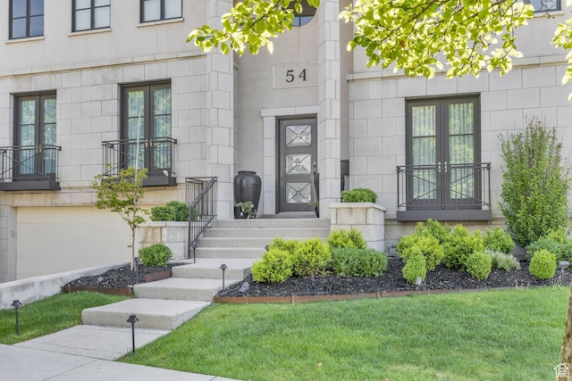 54 N B St, Salt Lake City, UT 84103 - property entrance featuring french doors, a garage, a yard, and stone siding