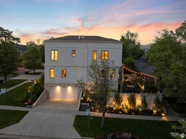 54 N B St, Salt Lake City, UT 84103 - view of front of home featuring an attached garage, driveway, stairway, a front lawn, and stucco siding