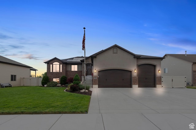 view of front facade featuring an attached garage, a gate, concrete driveway, roof mounted solar panels, and stucco siding