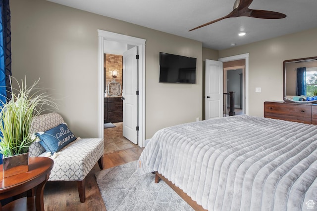 bedroom with wood finished floors, recessed lighting, ensuite bathroom, and ceiling fan