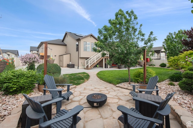 view of patio / terrace with a fire pit and stairway