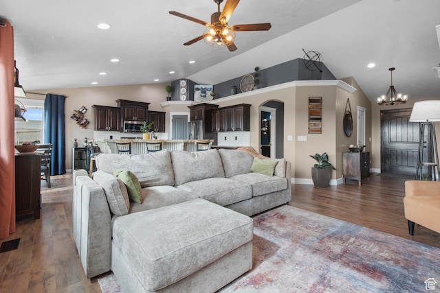 living room with lofted ceiling, a ceiling fan, wood finished floors, baseboards, and arched walkways