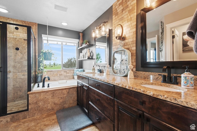bathroom with a stall shower, a garden tub, and double vanity