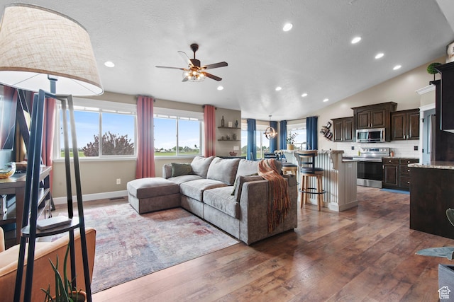 living room featuring ceiling fan, dark wood-style floors, recessed lighting, baseboards, and lofted ceiling
