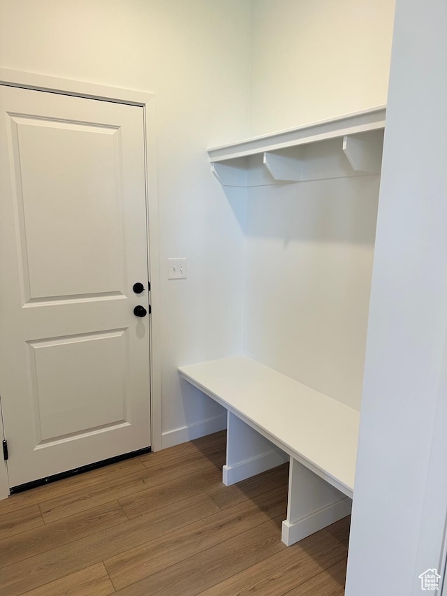mudroom with light wood finished floors and baseboards