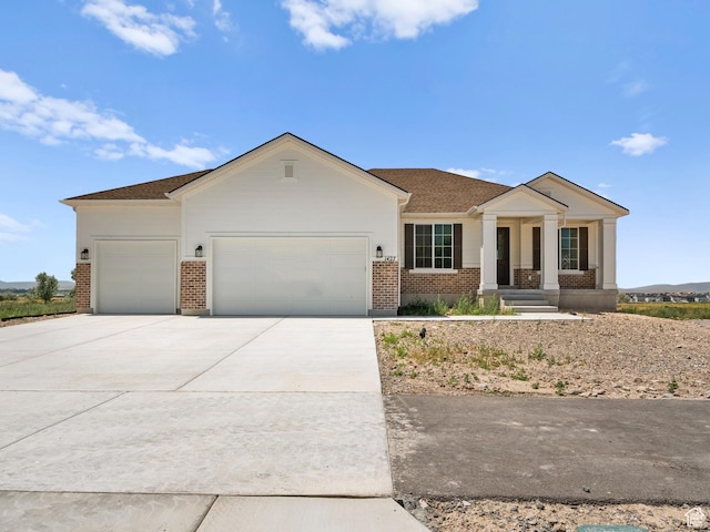 1427 N 290 E Unit 02, Salem, UT 84653 - view of front of property with brick siding, a garage, concrete driveway, and covered porch