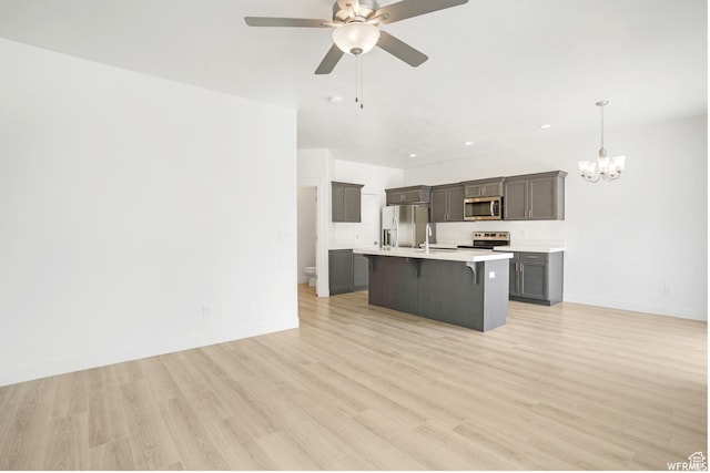172 S 880 E, American Fork, UT 84003 - kitchen with appliances with stainless steel finishes, a kitchen bar, a chandelier, light countertops, and baseboards
