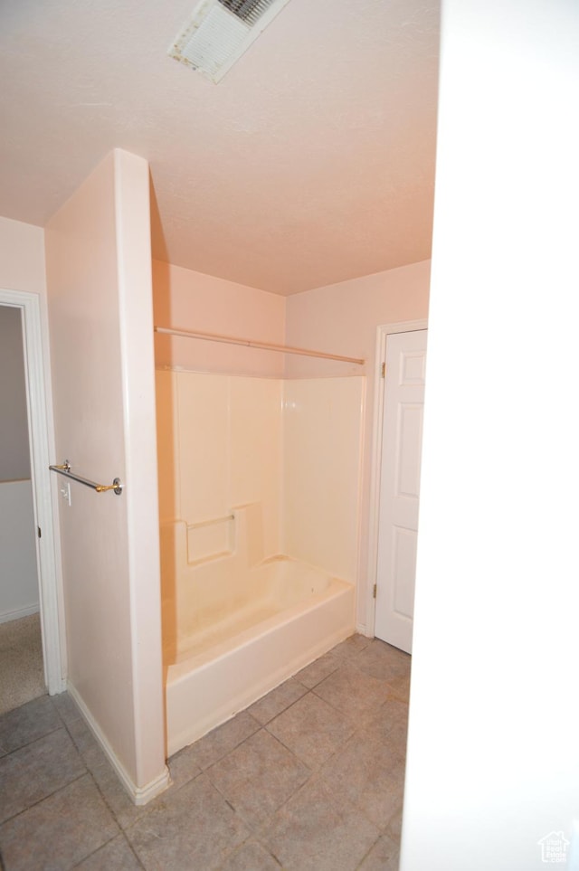 full bath featuring baseboards, tile patterned flooring, and shower / tub combination