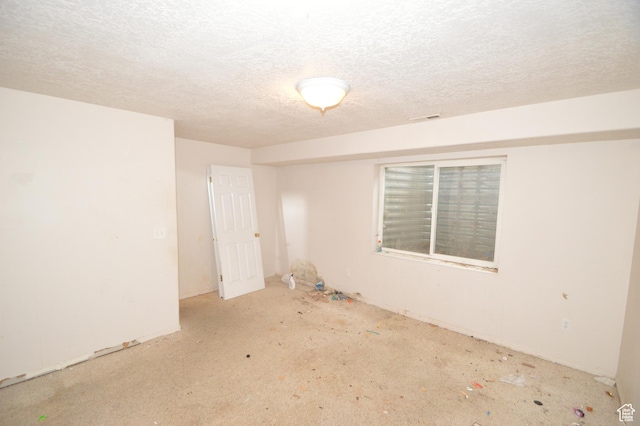 spare room with a textured ceiling
