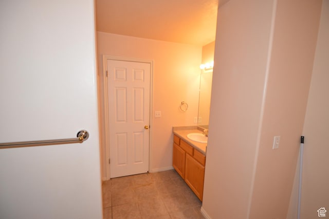 bathroom featuring vanity, tile patterned flooring, and baseboards