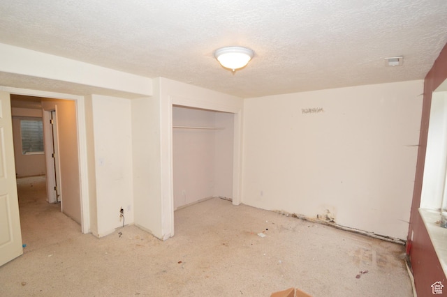 unfurnished bedroom featuring a closet and a textured ceiling