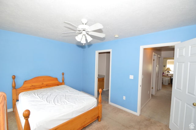 carpeted bedroom featuring baseboards and a ceiling fan