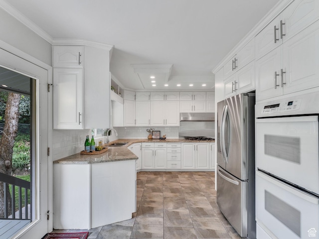4131 S Fortuna Way E, Salt Lake City, UT 84124 - kitchen featuring stainless steel refrigerator with ice dispenser, a sink, decorative backsplash, double oven, and white cabinets