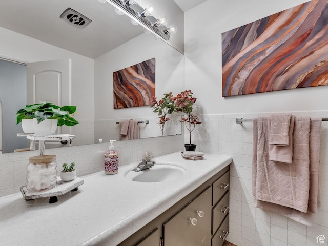 4131 S Fortuna Way E, Salt Lake City, UT 84124 - bathroom featuring tile walls, vanity, and wainscoting