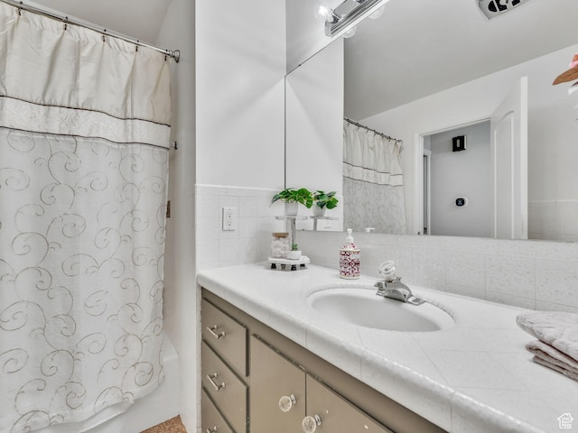 4131 S Fortuna Way E, Salt Lake City, UT 84124 - bathroom with vanity and decorative backsplash