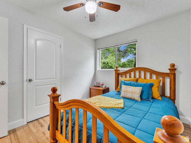 4131 S Fortuna Way E, Salt Lake City, UT 84124 - bedroom featuring light wood-type flooring, baseboards, a textured ceiling, and ceiling fan