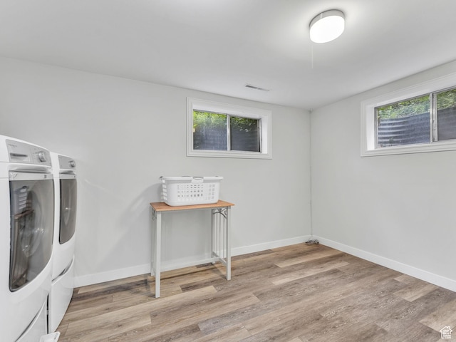 4131 S Fortuna Way E, Salt Lake City, UT 84124 - below grade area featuring washer and dryer, light wood-type flooring, plenty of natural light, and baseboards