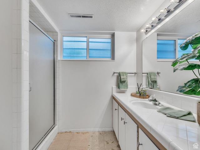 4131 S Fortuna Way E, Salt Lake City, UT 84124 - full bath featuring a shower stall, vanity, a textured ceiling, baseboards, and tile patterned floors