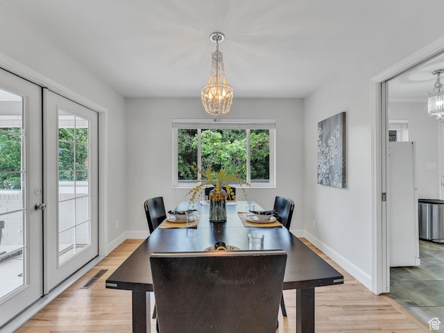 4131 S Fortuna Way E, Salt Lake City, UT 84124 - dining space featuring a chandelier, baseboards, and light wood-style floors
