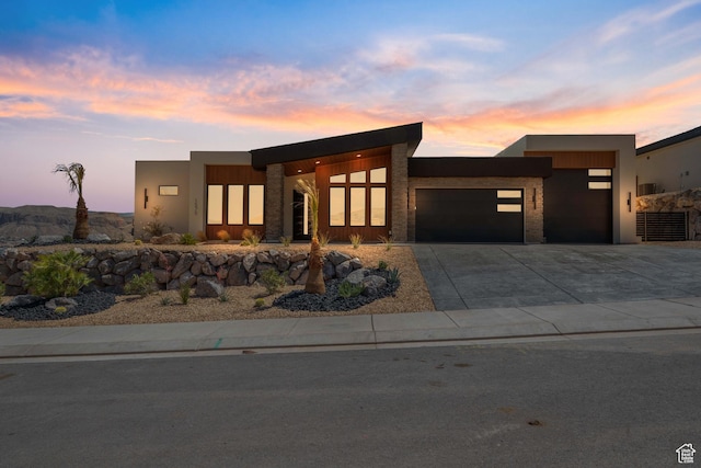 1575 W 840 S, Hurricane, UT 84737 - modern home featuring an attached garage, driveway, stucco siding, and stone siding