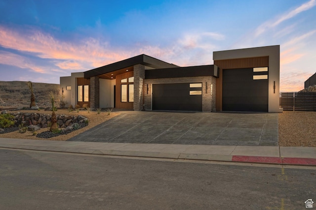 1575 W 840 S, Hurricane, UT 84737 - contemporary home featuring an attached garage, driveway, stucco siding, fence, and stone siding