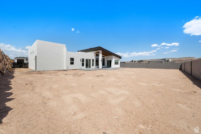 1575 W 840 S, Hurricane, UT 84737 - rear view of property featuring a fenced backyard and stucco siding