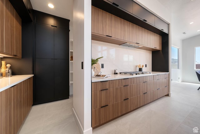 1575 W 840 S, Hurricane, UT 84737 - kitchen with modern cabinets, light countertops, stainless steel gas stovetop, light tile patterned floors, and tasteful backsplash
