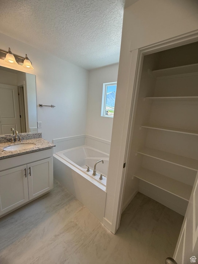 384 E 1480 N Unit 56, Salem, UT 84653 - bathroom featuring vanity, a bath, and a textured ceiling