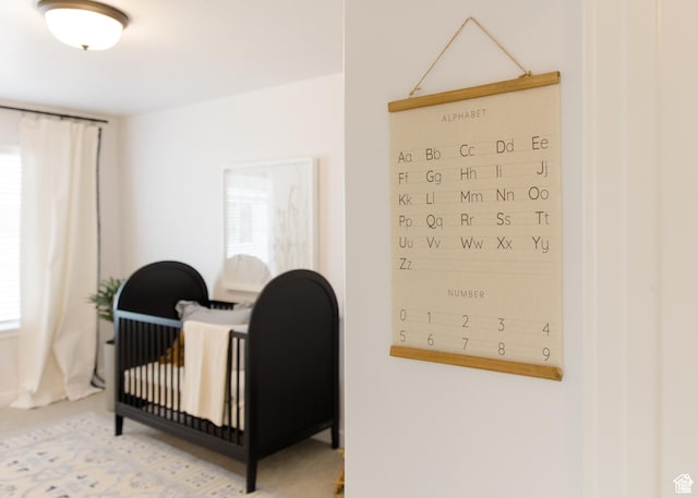 bedroom with multiple windows and a crib