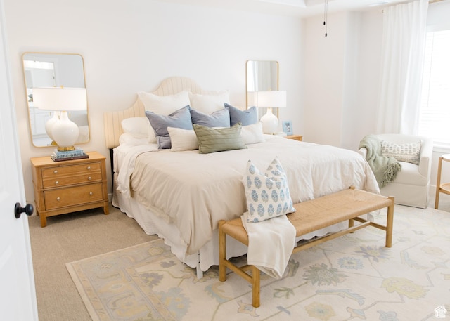 bedroom featuring light colored carpet
