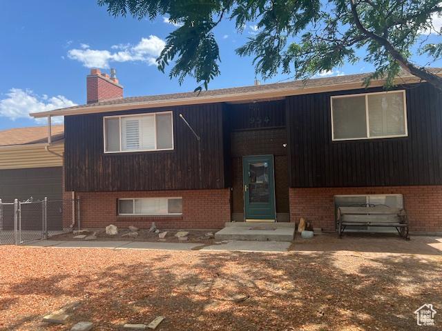 954 E 7725 S, Midvale, UT 84047 - split foyer home featuring a chimney and brick siding