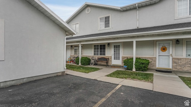 217 E 2300 N, North Ogden, UT 84414 - property entrance with covered porch, brick siding, and stucco siding