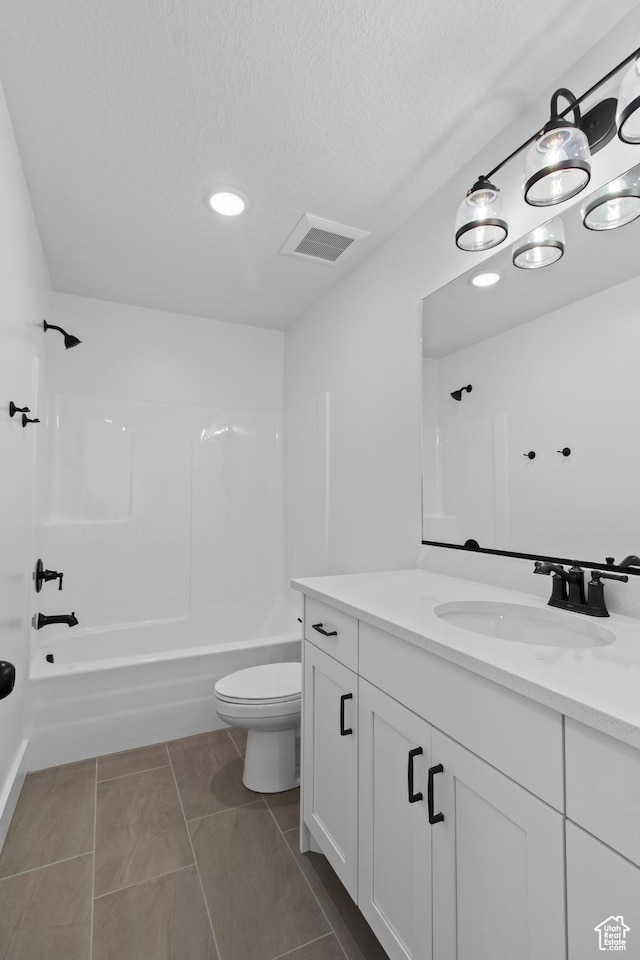 837 N 980 W Unit 66, Tremonton, UT 84337 - bathroom with toilet, tub / shower combination, vanity, a textured ceiling, and tile patterned floors
