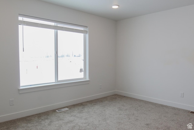 carpeted empty room with baseboards
