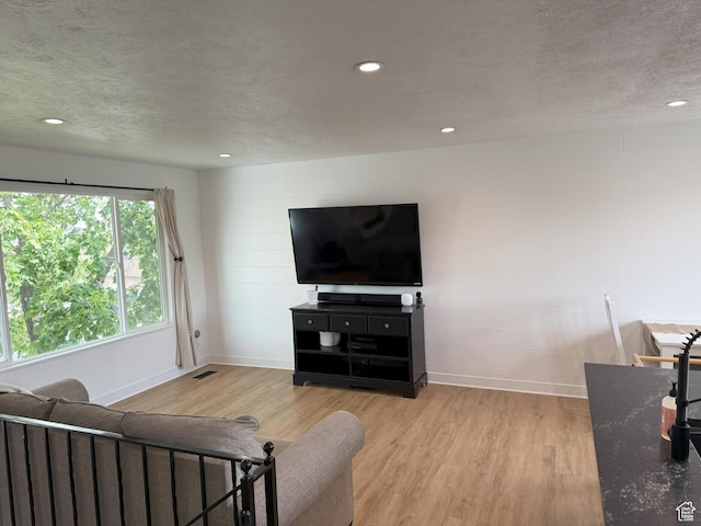 5582 W Joshua Cir S, West Jordan, UT 84081 - living area with light wood-style floors, baseboards, a textured ceiling, and recessed lighting