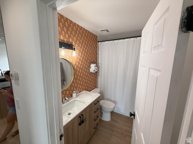 5582 W Joshua Cir S, West Jordan, UT 84081 - full bathroom with wallpapered walls, wood finished floors, vanity, toilet, and curtained shower