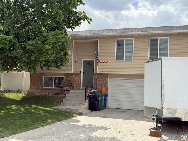 5582 W Joshua Cir S, West Jordan, UT 84081 - split foyer home featuring an attached garage, driveway, and brick siding