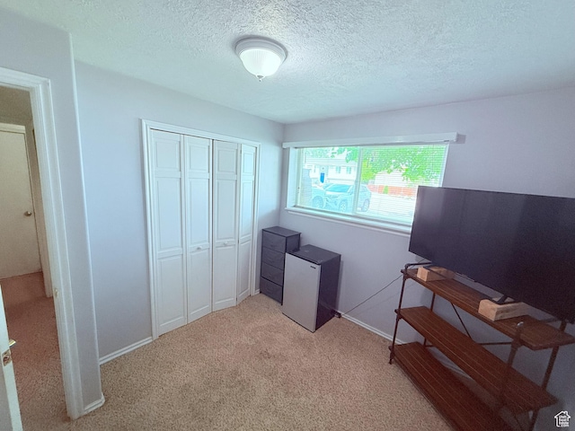 5582 W Joshua Cir S, West Jordan, UT 84081 - bedroom featuring light colored carpet, a closet, a textured ceiling, baseboards, and fridge