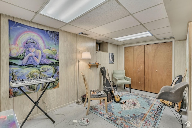 2172 S 800 E, Salt Lake City, UT 84106 - living area featuring a paneled ceiling, concrete flooring, baseboards, and wooden walls