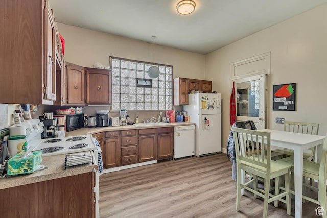 2172 S 800 E, Salt Lake City, UT 84106 - kitchen featuring white appliances, light countertops, hanging light fixtures, light wood finished floors, and a sink