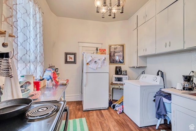 2172 S 800 E, Salt Lake City, UT 84106 - laundry room with washer / dryer, a chandelier, and light wood-type flooring