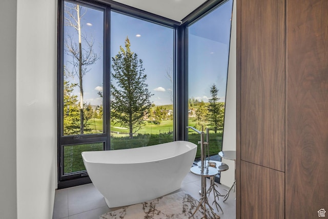 800 Hollyhock St, Park City, UT 84098 - bathroom featuring a freestanding tub, a wall of windows, and tile patterned floors