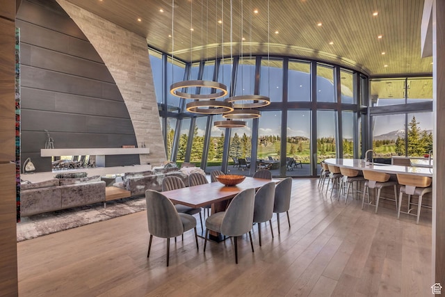 800 Hollyhock St, Park City, UT 84098 - dining area featuring floor to ceiling windows, a towering ceiling, plenty of natural light, and wood-type flooring