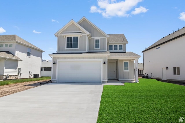 564 N 800 W, Smithfield, UT 84335 - view of front of home with board and batten siding, central air condition unit, concrete driveway, a garage, and a front lawn