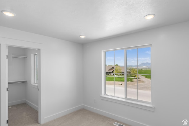 564 N 800 W, Smithfield, UT 84335 - unfurnished bedroom featuring light colored carpet, baseboards, a walk in closet, recessed lighting, and a closet